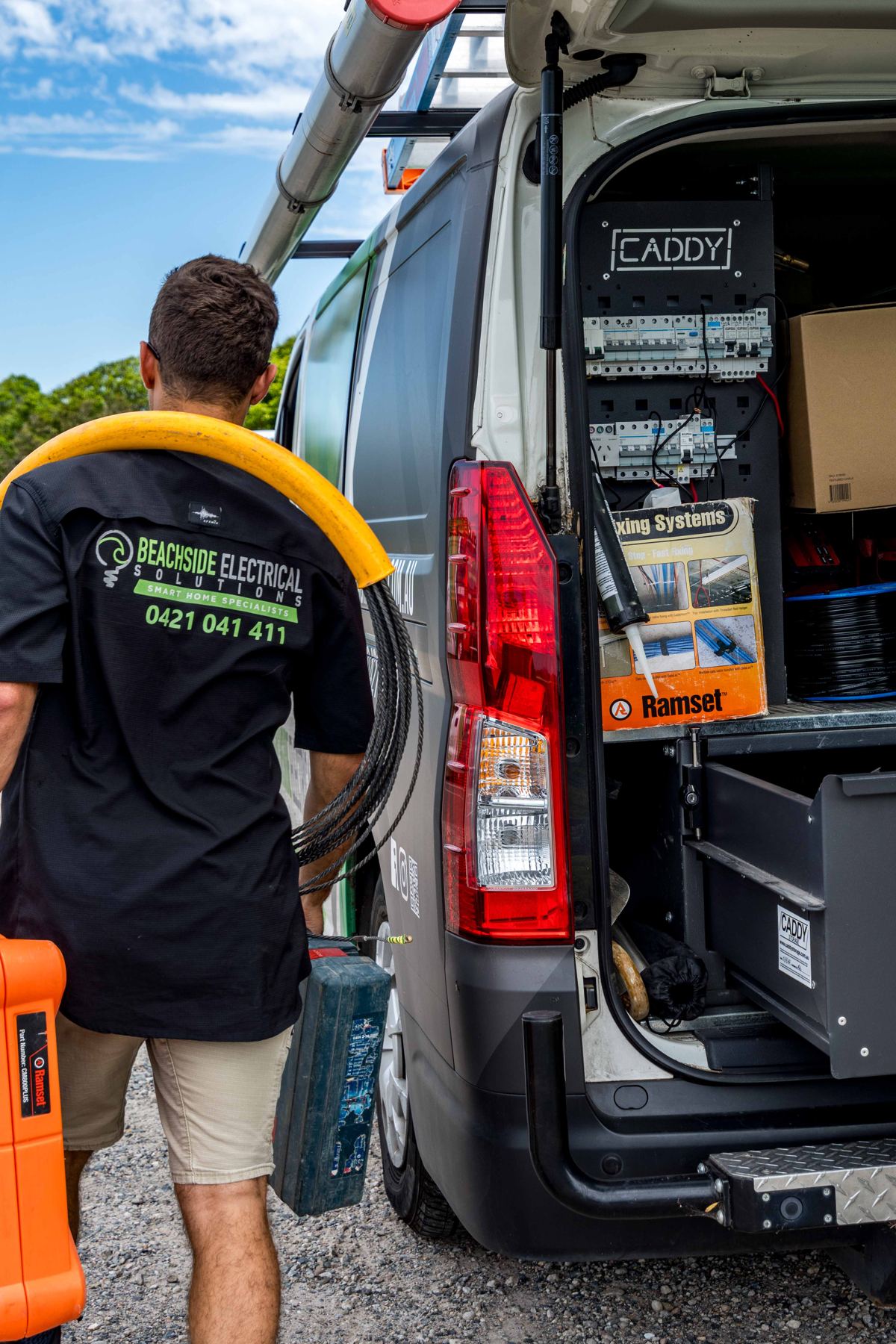 BSES technician carrying cable to site