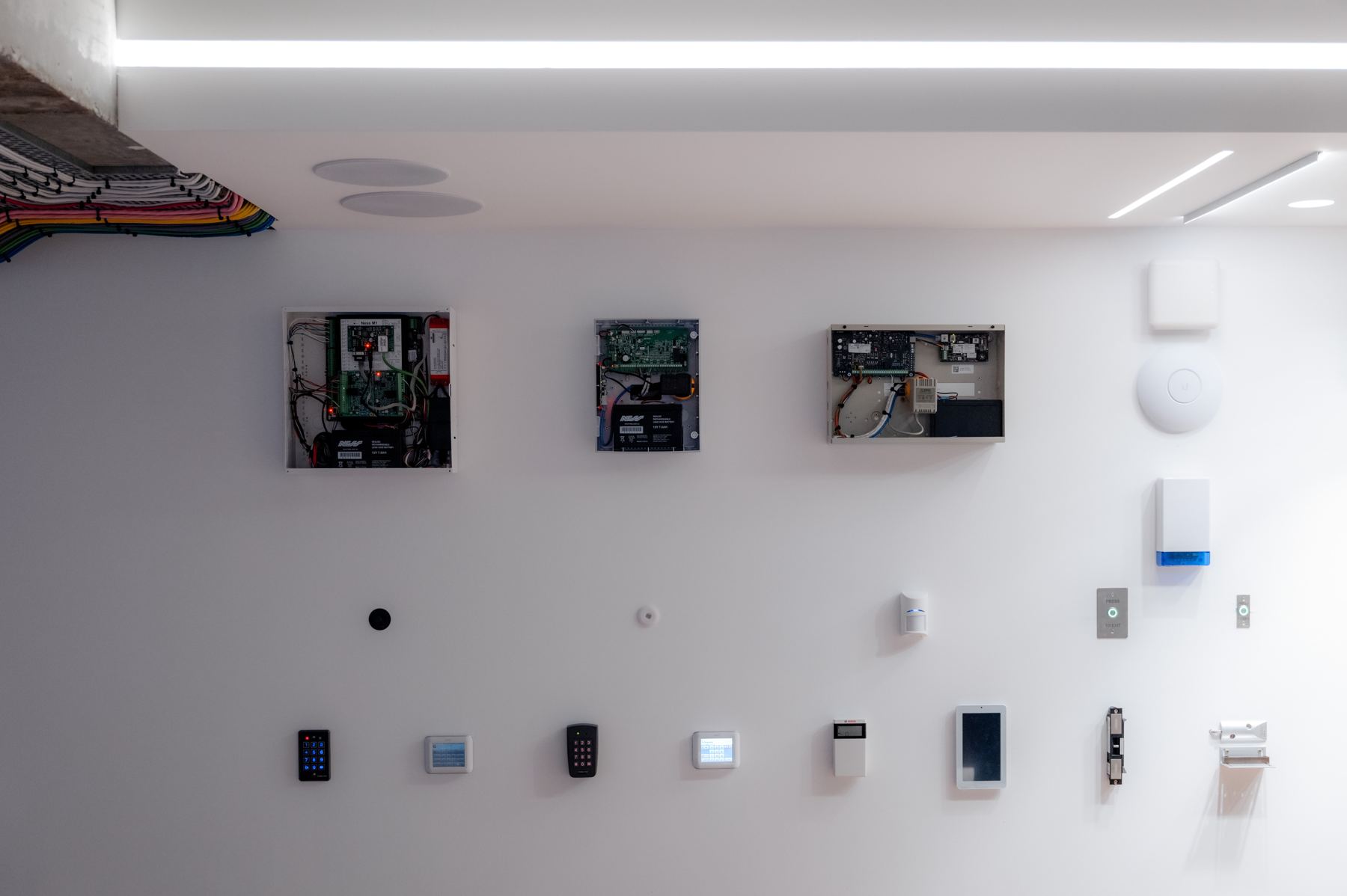 Alarm panels, keypads and readers on the showroom security wall