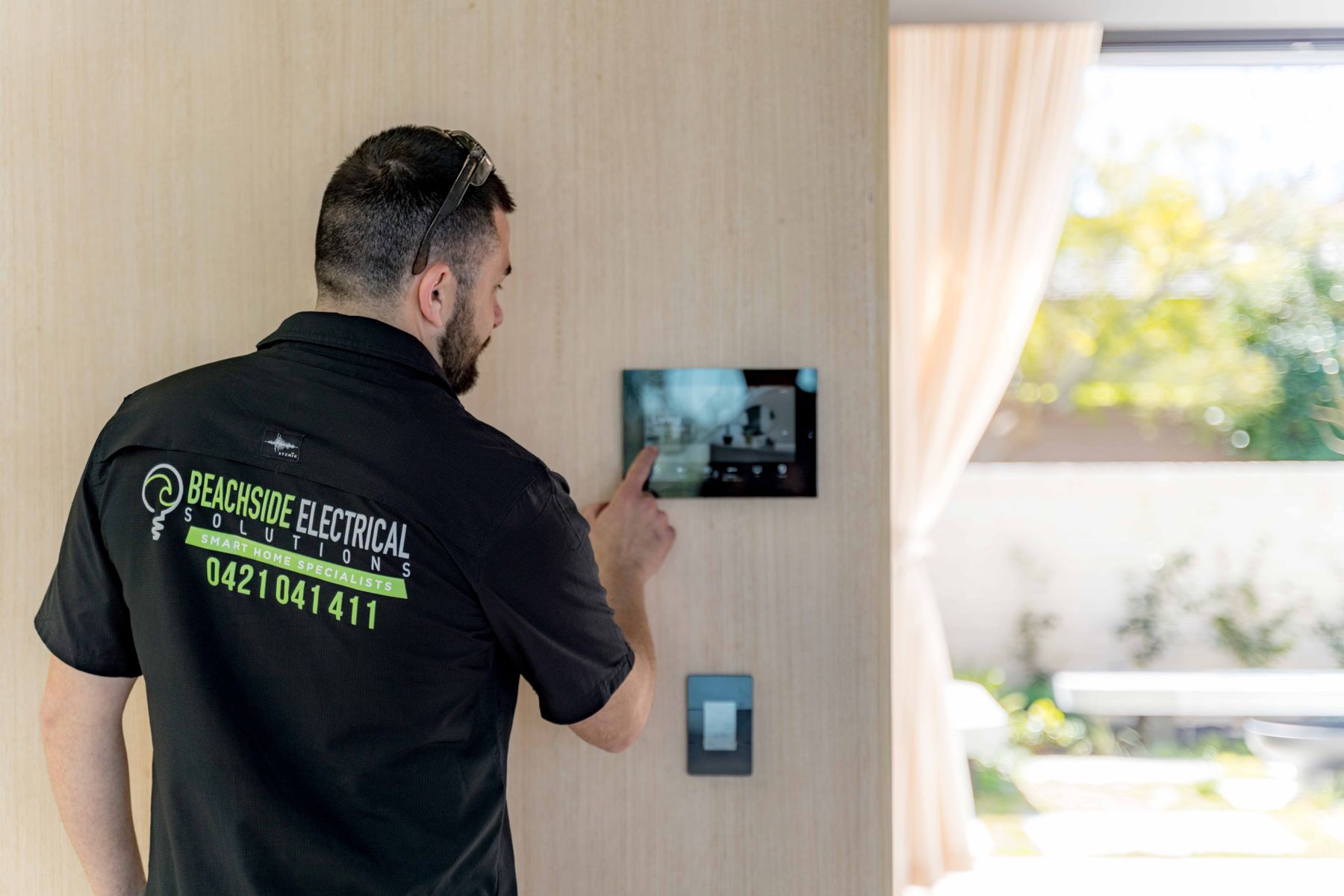 BSES technician using a Savant touch panel