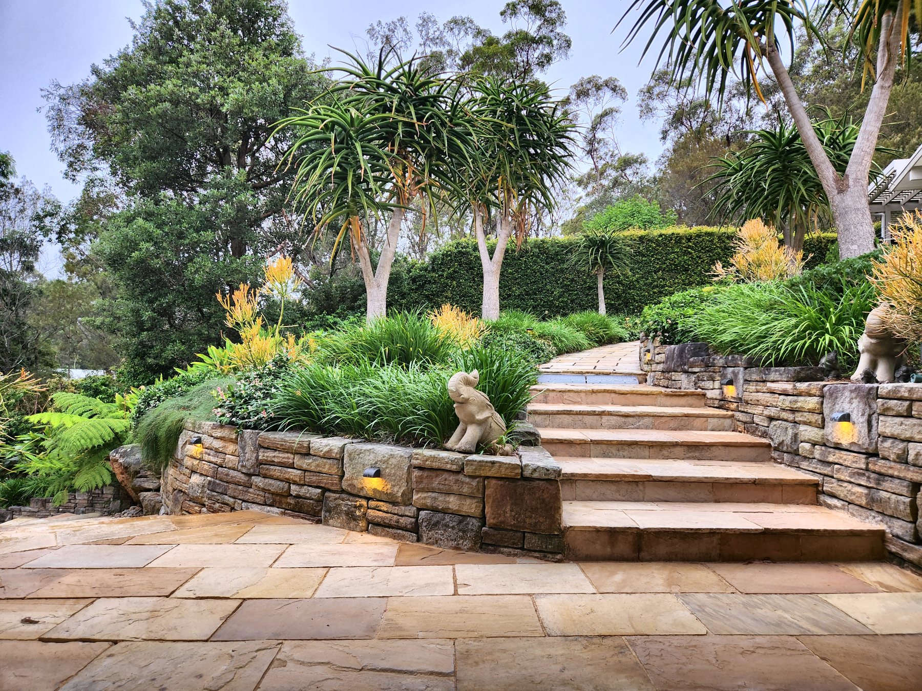 Garden steps with step lights set into sandstone retaining walls