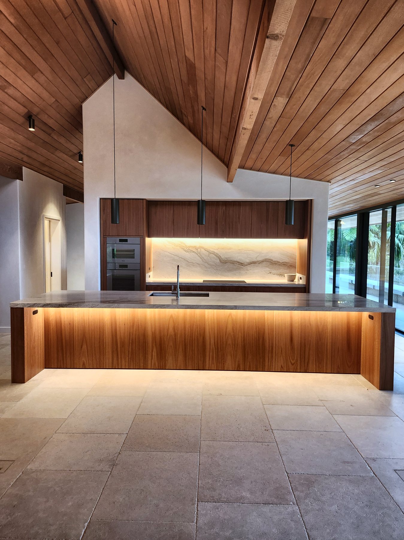 Kitchen island with under-bench LED and a lit marble splashback